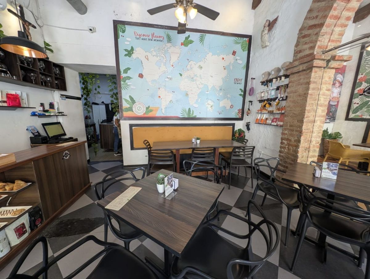 Café Central Traveler's Coffee — world map wall and work-friendly tables
